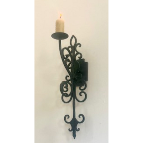 Elegant wrought iron wall sconce featuring intricate swirling designs and a candle holder. The warm glow of the candle adds a touch of charm and sophistication.