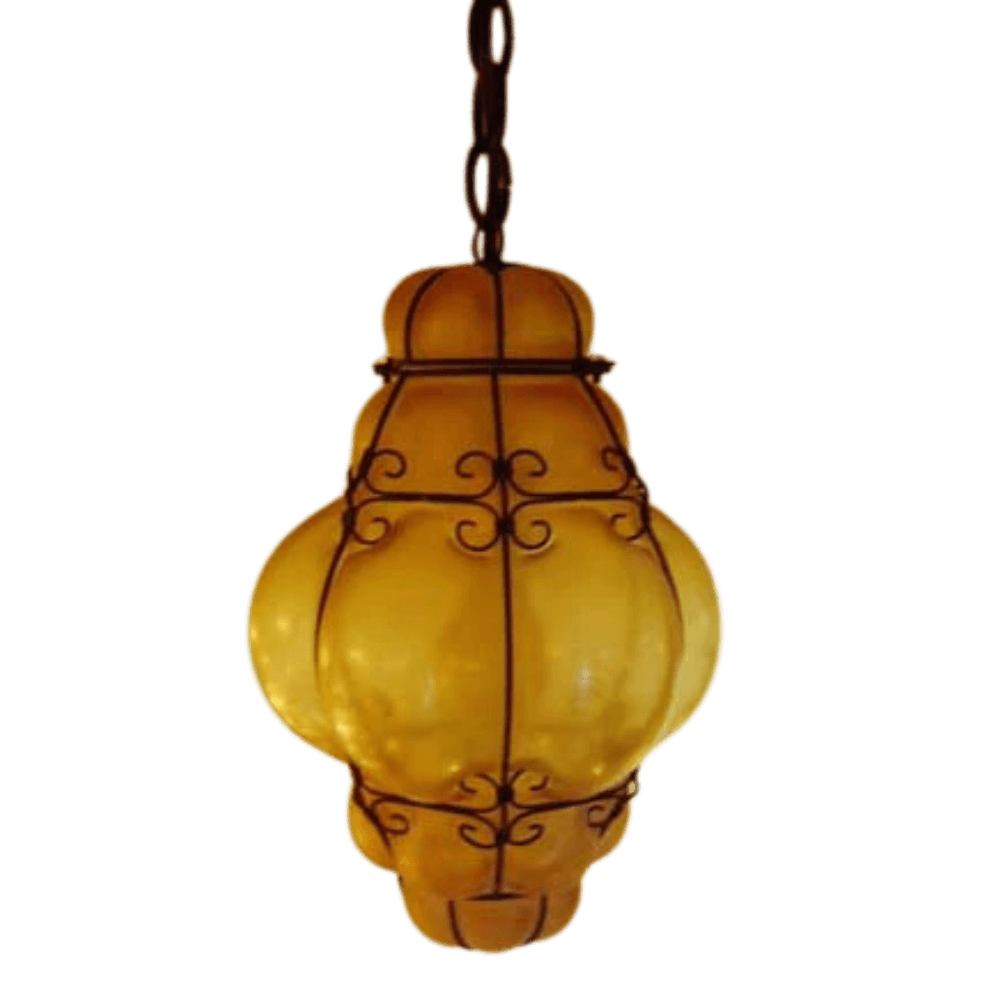 A beautifully crafted pendant featuring a twisted wrought iron frame showcasing a rounded, amber glass design. The warm glow emanates from the ornate glass, creating an inviting atmosphere. This unique fixture seamlessly blends artistry with function, ideal for enhancing any space with its distinctive charm.