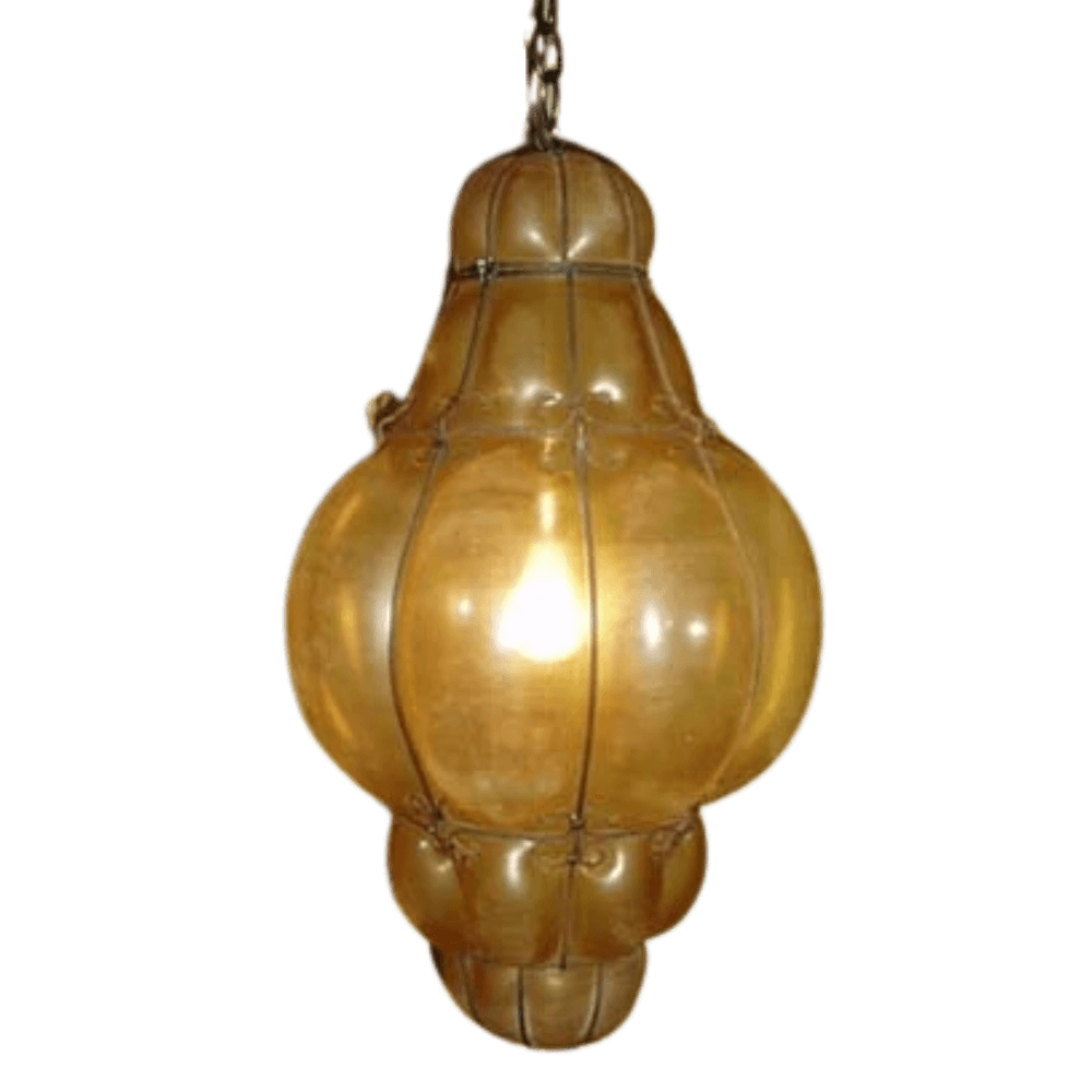 A beautifully crafted pendant light featuring a rounded, elongated shape with a warm, amber glow. The intricate wrought iron frame enhances its vintage charm, perfect for adding elegance to any space.