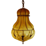 An elegant pendant light featuring a bulbous amber glass design, accented by intricate wrought iron detailing. Ideal for adding warmth and charm to any space.