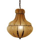 A stunning pendant light featuring an elegant, rounded shape with a warm amber hue. The design includes intricate black detailing, enhancing its classic charm. Perfect for adding a touch of sophistication to any space.