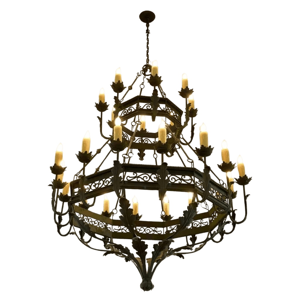 A grand chandelier featuring intricate wrought iron craftsmanship, showcasing multiple tiers adorned with candle-like bulbs and detailed leaf accents.