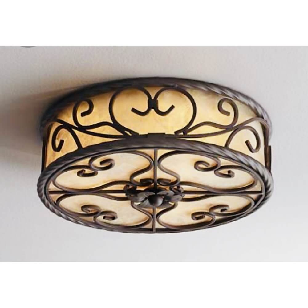 A beautifully crafted ceiling light featuring ornate wrought iron designs and a warm, amber glass shade. The intricate scrollwork adds elegance, making it a perfect focal point for any room.