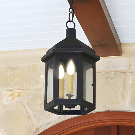 A stylish wrought iron pendant featuring a geometric design, with two candle-style bulbs illuminating through clear glass panels, suspended by a sturdy chain.