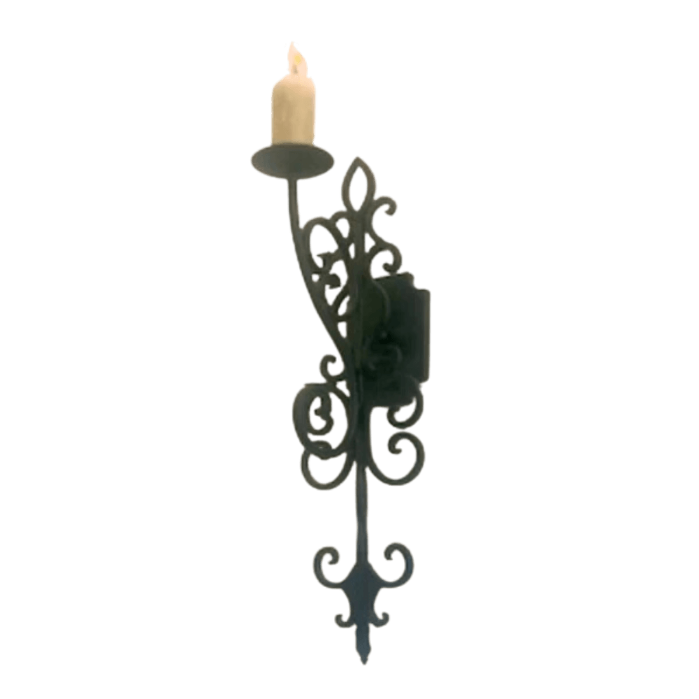 A decorative wrought iron wall sconce featuring intricate scrolling designs, holding a single candle. The elegant craftsmanship enhances any space with a warm, inviting glow.