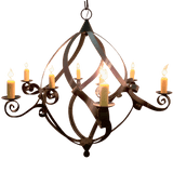 Elegant wrought iron chandelier featuring sweeping curves and multiple candle holders, designed to illuminate spaces with warm, inviting light.