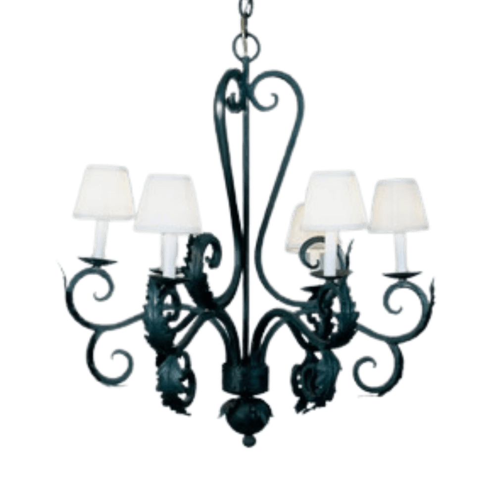 A detailed wrought iron chandelier featuring ornate scrollwork and five candle-like fixtures with white shades, providing a warm and inviting ambiance.