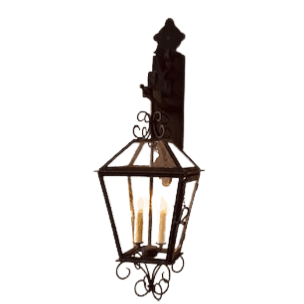 A custom wrought iron sconce featuring intricate scrollwork and a charming, traditional design. It holds four candle-style bulbs, providing warm illumination. Perfect for adding elegance to any space.