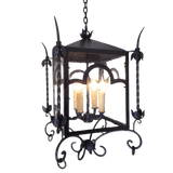 A decorative hanging fixture featuring elegant scrollwork and floral accents, housing three candle-style bulbs. The design combines rustic charm with artistic craftsmanship, ideal for enhancing any space.