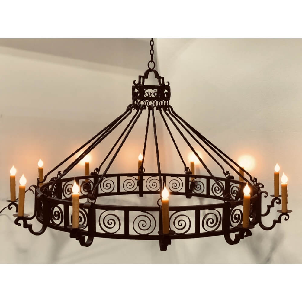 A striking wrought iron chandelier featuring an intricate scroll design with multiple candle-style lights. The circular frame hangs gracefully, showcasing an elegant blend of craftsmanship and warmth, perfect for enhancing any traditional or rustic space.