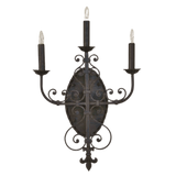 Elegant wrought iron wall sconce featuring three candle-like lights atop decorative arm supports. The intricate design includes swirling motifs and an oval backplate, adding a touch of sophistication and warmth to any space.