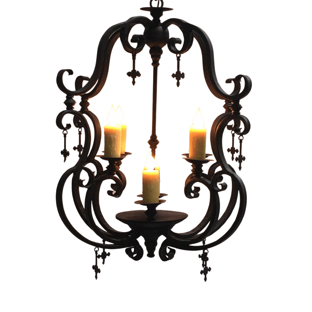 A graceful wrought iron chandelier featuring intricate scrollwork. It showcases three candle holders with flickering candles, creating a warm and inviting ambiance.