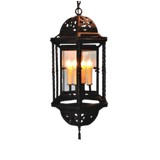 A stunning wrought iron pendant featuring an ornate design with a rounded canopy. The fixture showcases multiple glass panels that elegantly encase three glowing candles, creating a warm and inviting ambiance. The intricate details of the ironwork highlight craftsmanship and style, making it a striking addition to any space.