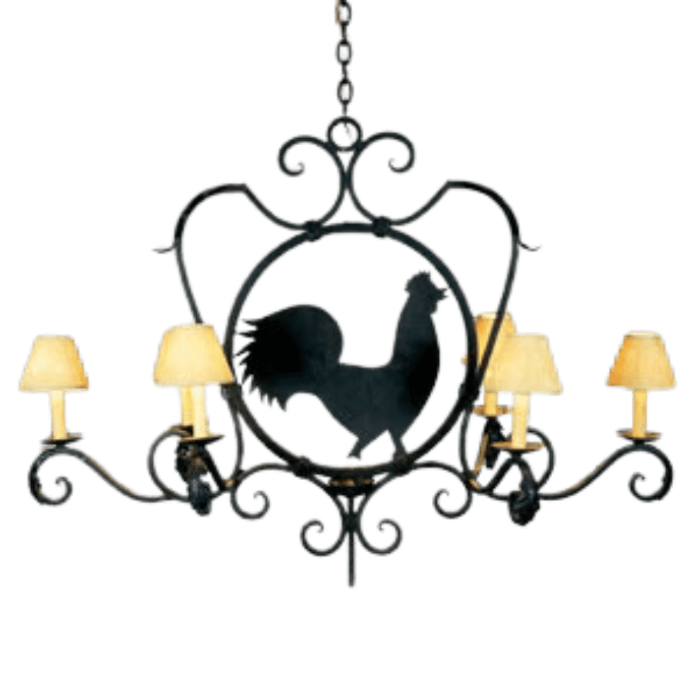 A decorative wrought iron chandelier featuring a central silhouette of a rooster surrounded by intricate scrollwork. It has five arms, each topped with soft, cream-colored shades that diffuse light warmly. The elegant design combines rustic charm with artistic detailing, making it a unique focal point for any space.