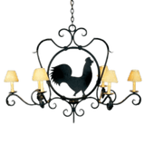 A decorative wrought iron chandelier featuring a central silhouette of a rooster surrounded by intricate scrollwork. It has five arms, each topped with soft, cream-colored shades that diffuse light warmly. The elegant design combines rustic charm with artistic detailing, making it a unique focal point for any space.