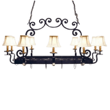 A graceful wrought iron chandelier featuring elegantly curved arms and soft fabric shades. The design combines rustic charm with sophistication, creating a warm ambiance for any space. Perfect for adding a touch of timeless elegance.