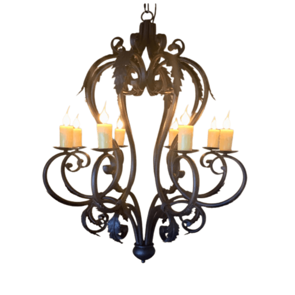 A decorative wrought iron chandelier with ornate curves and leaf designs, featuring six candle-style lights that radiate warmth and elegance.