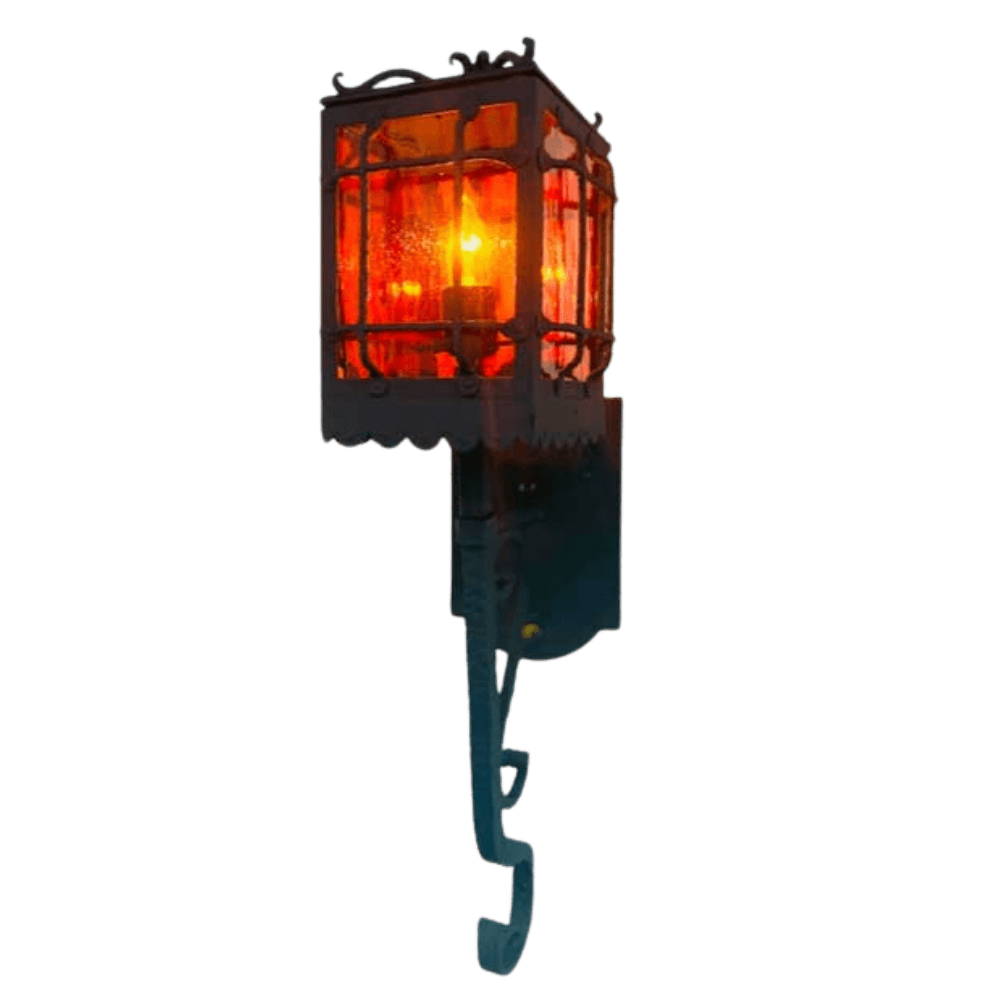 A striking wrought iron wall sconce featuring a decorative grid design and warm amber glass. The intricate detailing enhances its rustic charm, ideal for adding a touch of elegance to any space.