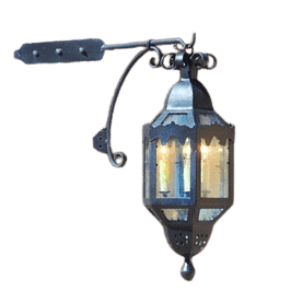 A decorative wrought iron sconce featuring decorative scrollwork and a lantern-like shape, illuminated by warm light, ideal for enhancing ambiance.