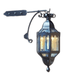 A decorative wrought iron sconce featuring decorative scrollwork and a lantern-like shape, illuminated by warm light, ideal for enhancing ambiance.