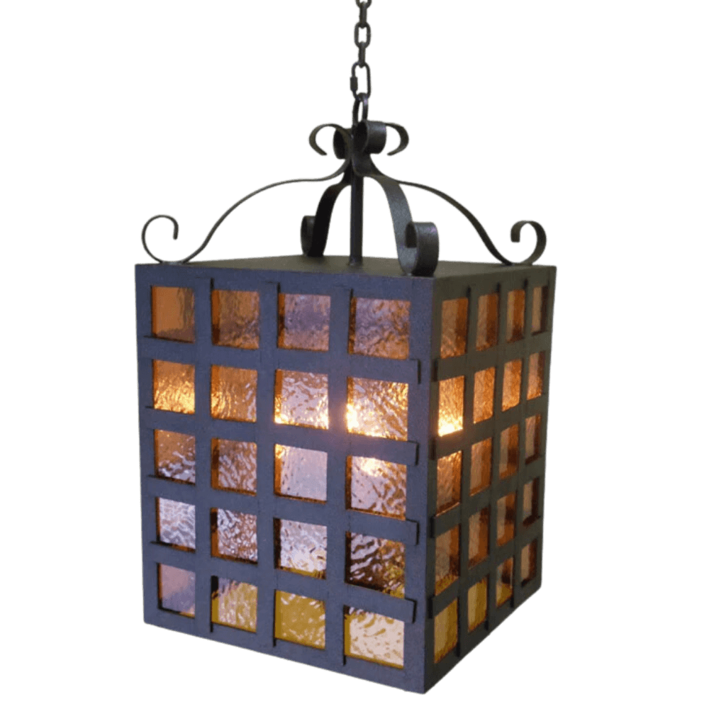 A hanging pendant light with a square design, featuring textured glass panels in warm hues. The wrought iron frame adds a rustic charm, accented by elegant scrollwork at the top, illuminating spaces with a cozy ambiance.