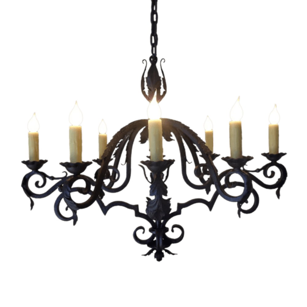 A beautifully crafted wrought iron chandelier featuring six elegantly curved arms, each adorned with flickering candle-style bulbs. The intricate design showcases swirling patterns and an ornate centerpiece, perfect for adding a touch of sophistication to any indoor space.