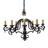 A beautifully crafted wrought iron chandelier featuring six elegantly curved arms, each adorned with flickering candle-style bulbs. The intricate design showcases swirling patterns and an ornate centerpiece, perfect for adding a touch of sophistication to any indoor space.