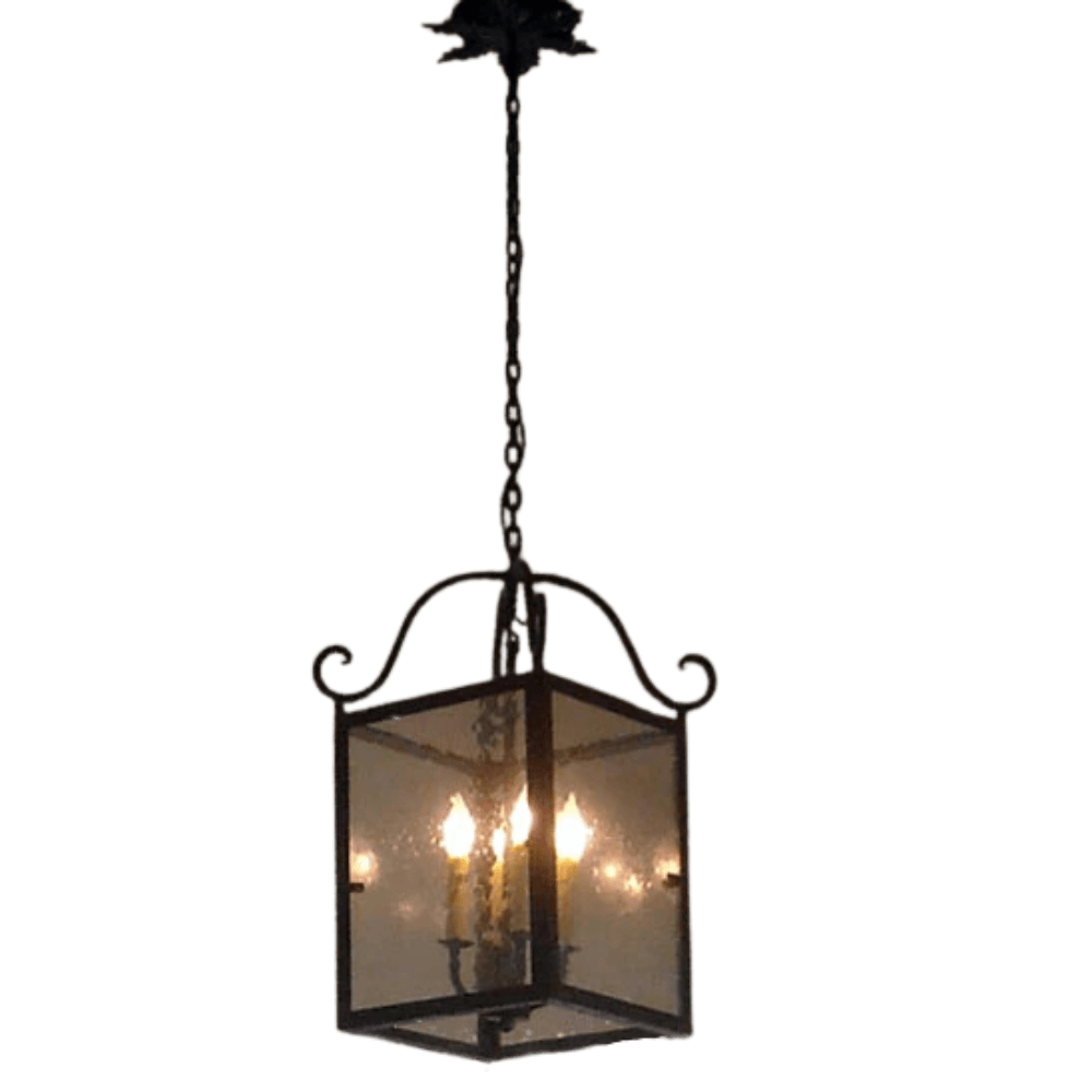 A charming wrought iron pendant light featuring a geometric glass design with elegant curves and four candle-inspired bulbs, perfect for adding warmth to any space.