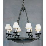 An elegant wrought iron chandelier features a round base with a textured, dark finish, adorned with six candle-style lights topped with white fabric shades. The design includes intricate scrollwork and a chain for hanging, creating a warm and inviting atmosphere.