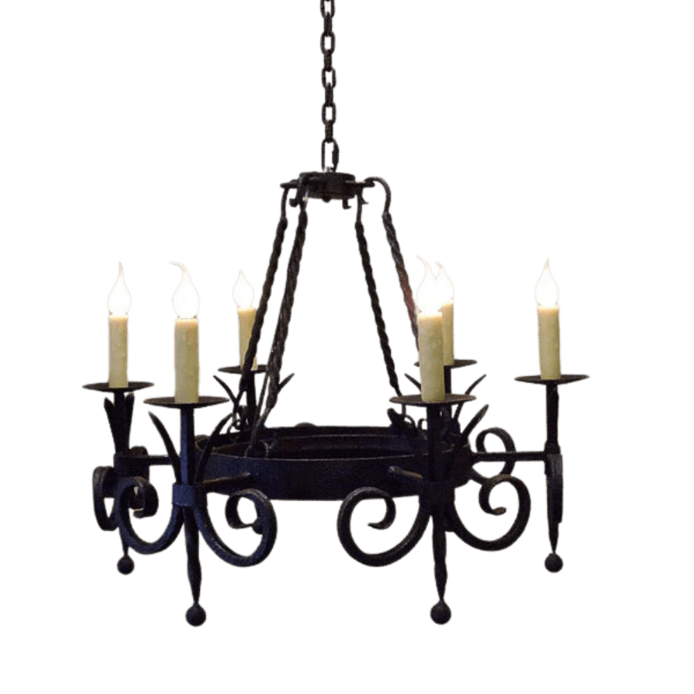 Wrought iron chandelier featuring elegant curves and scrollwork, holding five candle-like light bulbs. Suspended from a chain, it adds a warm, rustic charm to any space.