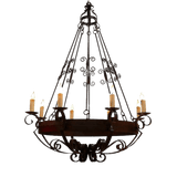 A beautifully crafted chandelier featuring intricate wrought iron design, adorned with multiple candle-like lights. The dark, rich tones and elegant curves add a touch of sophistication and warmth to any space, creating an inviting ambiance. Perfect for enhancing dining areas or living rooms with classic charm.