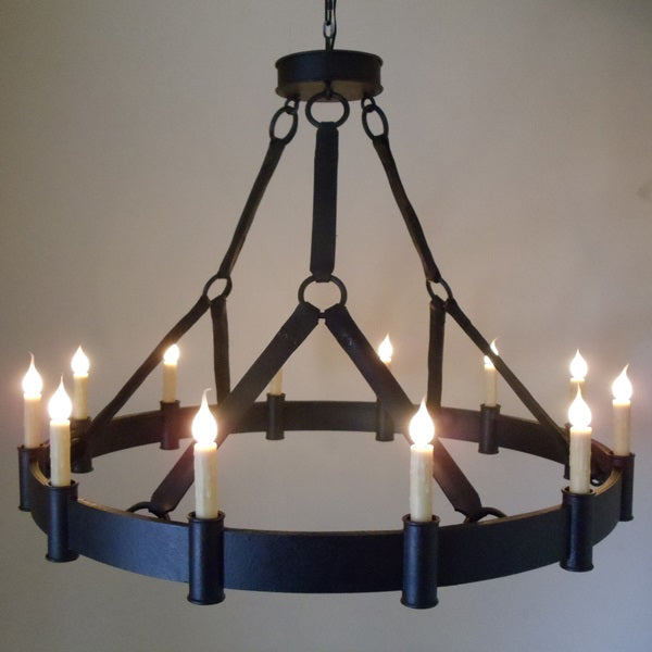 A striking wrought iron chandelier featuring a circular design with twelve candle-style fixtures, each illuminated with a soft, flickering glow. The elegant structure is suspended by sturdy chains, showcasing a blend of rustic charm and sophisticated craftsmanship, perfect for adding warmth to any space.