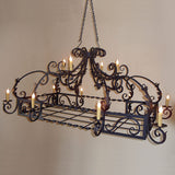 A decorative wrought iron chandelier featuring intricate scrollwork and twelve candle-like lights. The piece is suspended from a chain, adding elegance to any space.