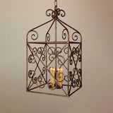 A decorative, wrought iron pendant light featuring intricate scrollwork and a traditional shape. Three candle-style bulbs illuminate the design, enhancing its elegant, rustic charm.