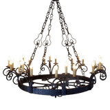 A large, ornate chandelier featuring intricate wrought iron designs and multiple candle-style lights. The fixture showcases elegant scrollwork and a rustic finish, suspended by detailed chains, perfect for adding charm to any space.