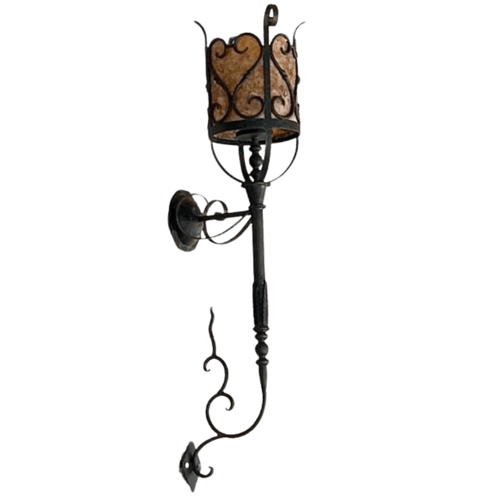 A decorative wall sconce featuring intricate wrought iron detailing and a warm, textured lamp shade. The elegant design includes graceful curves and scrollwork, perfect for enhancing interior spaces with a timeless charm.