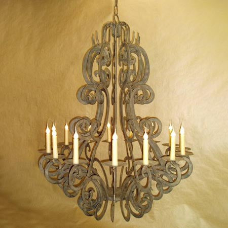 A beautifully crafted wrought iron chandelier featuring intricate scrollwork and elegant candle holders. The design showcases a mix of artistry and sophistication, perfect for enhancing any space with a warm glow.