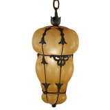 A beautifully crafted pendant featuring an elegant, bulbous design with softened, amber glass. The intricate wrought iron detailing adds a touch of sophistication, enhancing any space with warm, inviting illumination.