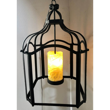 A beautifully crafted wrought iron pendant featuring an intricate design with a cylindrical, warm-lit centerpiece. Ideal for adding a rustic charm to any space.