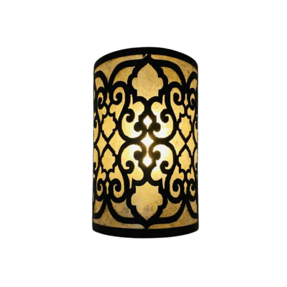 A cylindrical wall sconce featuring intricate, swirling wrought iron patterns. The design contrasts with the warm glow of light emanating from within, creating a cozy and elegant atmosphere.