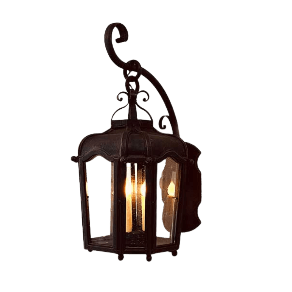 A decorative wrought iron sconce featuring a classic design with elegant curves and a lantern-style structure. It holds multiple candle-like lights, casting a warm glow. The intricate details enhance its charm, making it a stylish addition to any space.