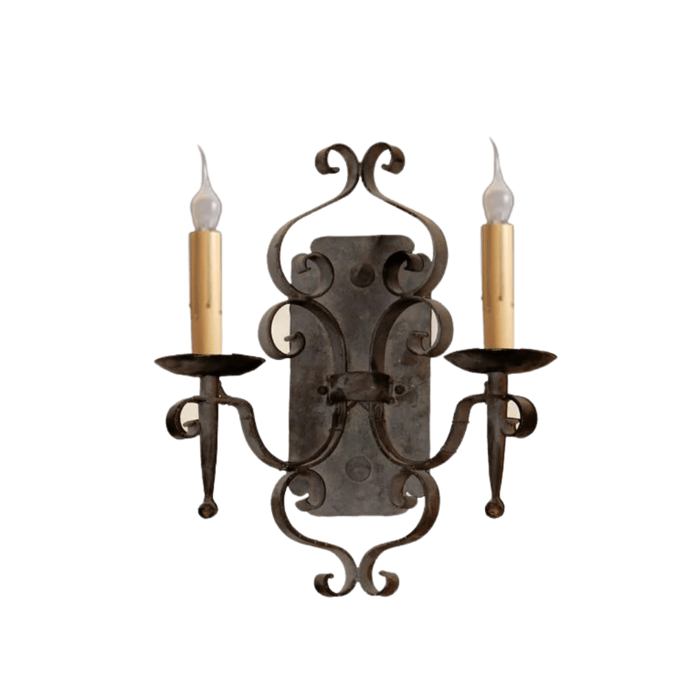 An elegant wrought iron wall sconce featuring intricate scrollwork and two candle-shaped lights. The design incorporates a dark finish with light-colored candle holders, creating a warm and inviting ambiance. Ideal for enhancing traditional or rustic decor.