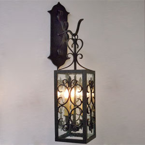 Wrought iron wall sconce featuring intricate scrollwork and a stylish structure, enhancing any space with warm illumination and elegant design.