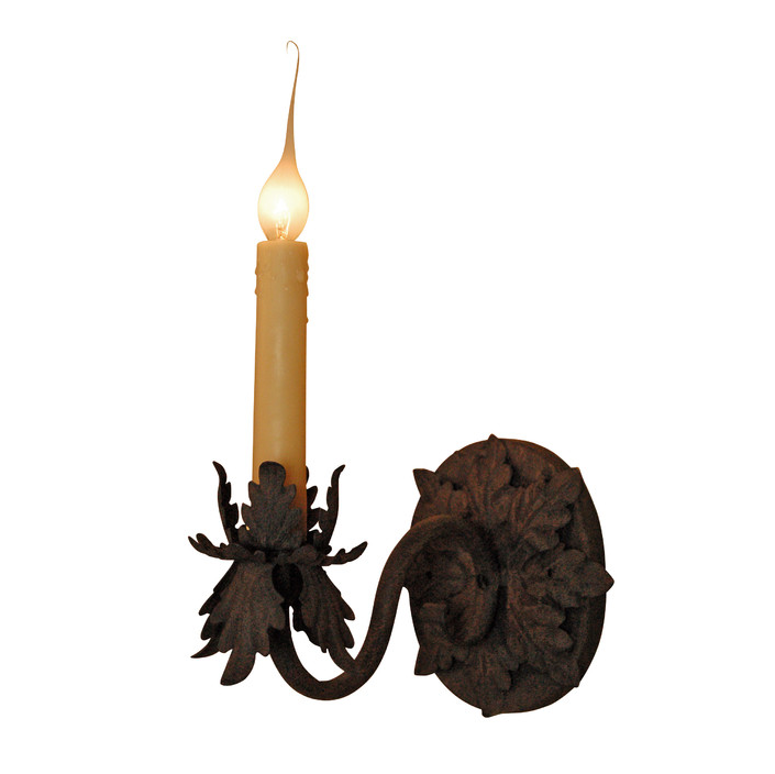 A decorative wrought iron wall sconce featuring a curling arm and an elegantly shaped candle holder. The flickering candle adds a warm glow, highlighting the intricate leaf motifs on the base. This fixture combines artistry with functional beauty, perfect for enhancing any interior space.