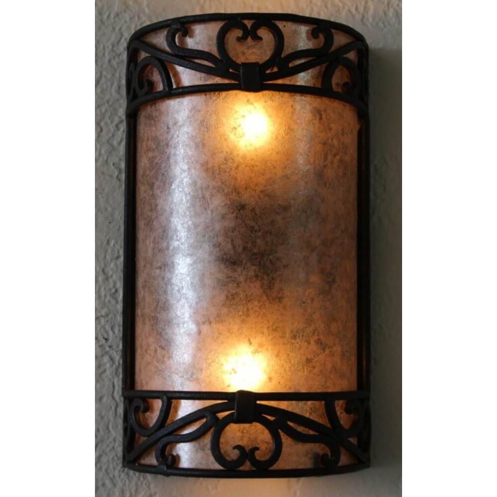 A wrought iron sconce featuring an elegant, curved design with intricate scrollwork. The warm amber glass emits a soft glow, enhancing any space with its classic charm.