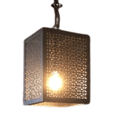 A unique pendant light featuring a square metal frame with intricate cut-out patterns, casting a warm glow from the central bulb. Ideal for adding character to any space.