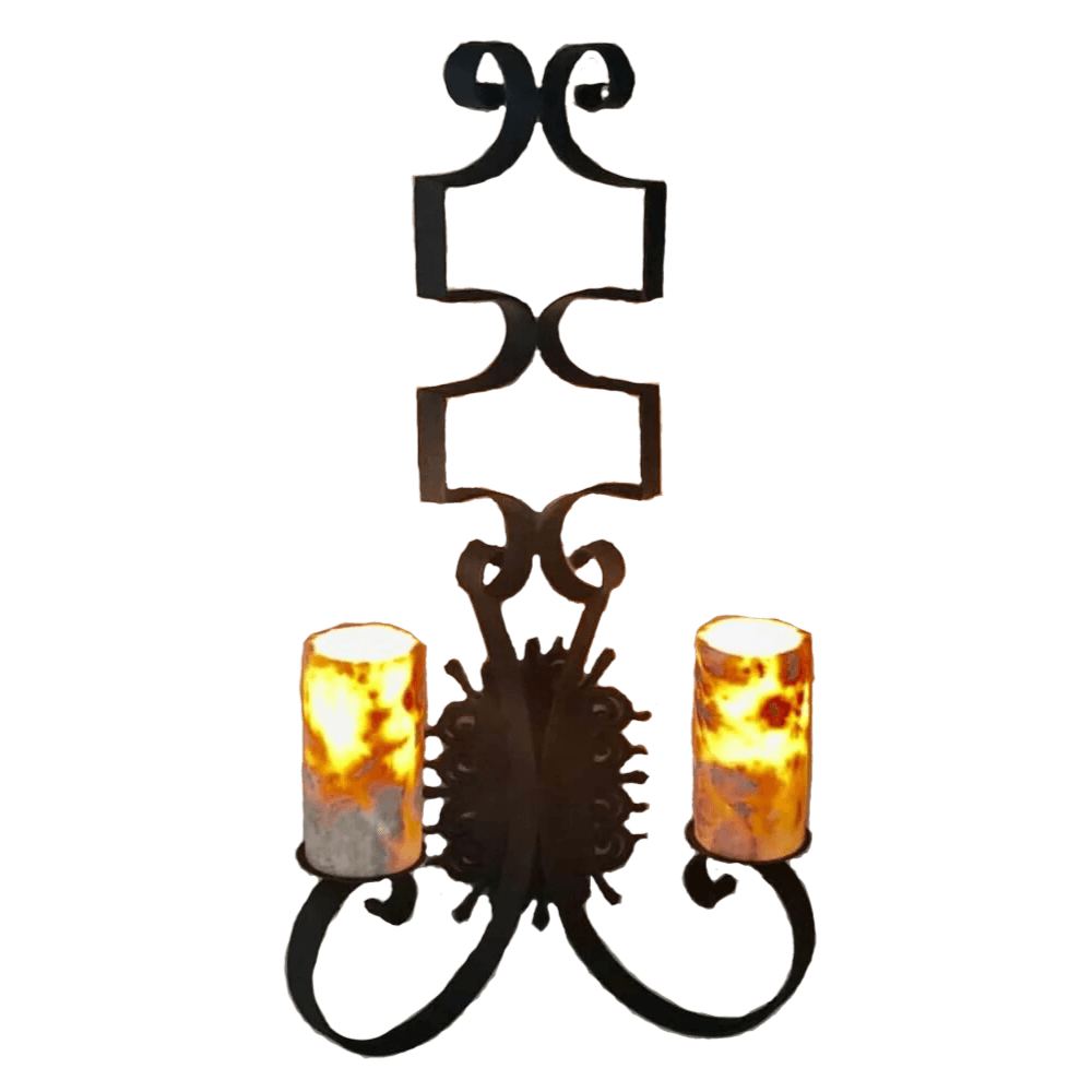 A decorative wall sconce featuring an elegant wrought iron design with flowing curves and stylized scrollwork. It has two candle-like lights with amber and gray hues, providing a warm, inviting glow.