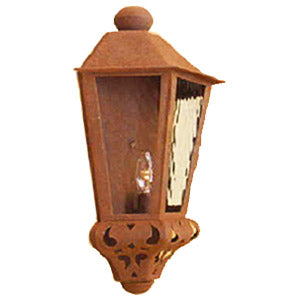 A rustic wrought iron sconce featuring intricate cut-out designs, a warm patina finish, and a glass enclosure that showcases an elegant bulb, perfect for enhancing ambient lighting.