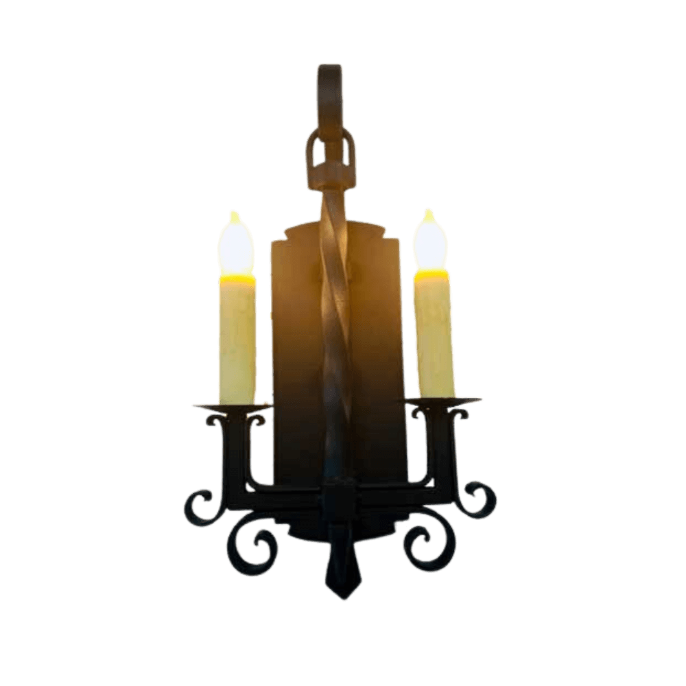 A hand-crafted wrought iron sconce featuring two candle-like lights and elegant scrollwork. The twisted center adds a touch of artistry and charm.