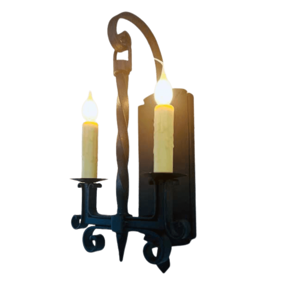 A beautifully crafted wall sconce featuring two candle-like lights, set against an elegant black wrought iron backdrop. The twisted arm design adds a classic touch, enhancing the warm glow and creating an inviting ambiance.